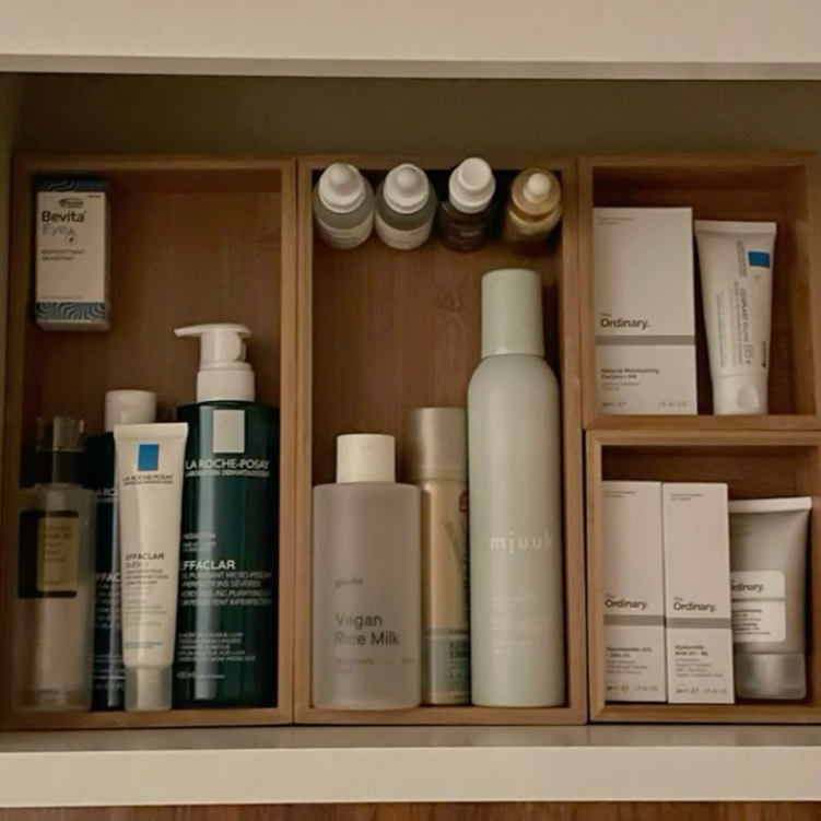 Wooden cabinet with skincare products on a neutral background